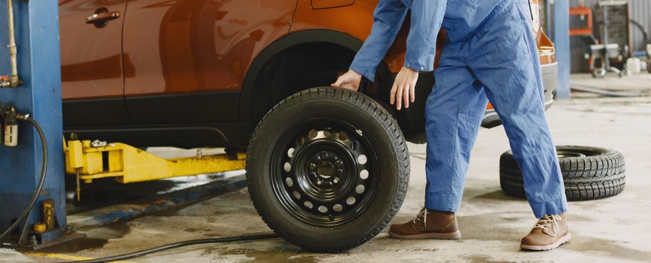 Man working on vehicle wheels